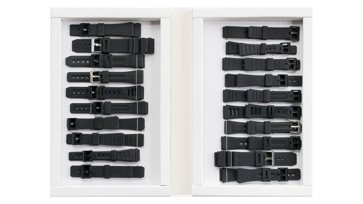 Range of 20 synthetic rubber straps in a display case